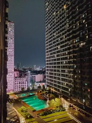 a view of a large building with a swimming pool at SMDC FAME in Ortigas in Manila