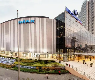 a large building with a sign on top of it at Heart of Ortigas in Manila
