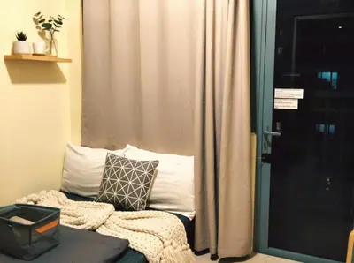 a room with a window with a couch and a curtain at Heart of Ortigas in Manila