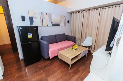 a small living room with a couch and a table at 2 Bedroom Penthouse Air condo Makati Gym Swim Park 300 Mbps in Manila