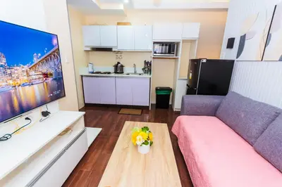 a living room with a couch and a table at 2 Bedroom Penthouse Air condo Makati Gym Swim Park 300 Mbps in Manila