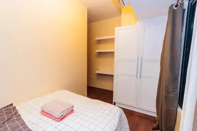 a small bedroom with a bed and a closet at 2 Bedroom Penthouse Air condo Makati Gym Swim Park 300 Mbps in Manila