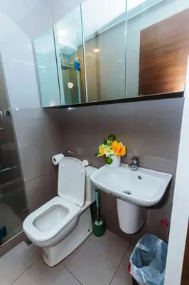 a bathroom with a toilet and a sink at 2 BR Air condo Makati Penthouse SwimGym 300Netflix 5249 in Manila