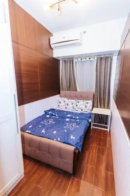 a small bedroom with a bed in a room at 2 BR Air condo Makati Penthouse SwimGym 300Netflix 5249 in Manila