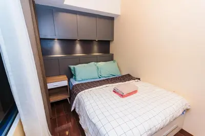 a small bedroom with a bed and a cabinet at 2 BR Air condo Makati Penthouse SwimGym 300Netflix 5249 in Manila