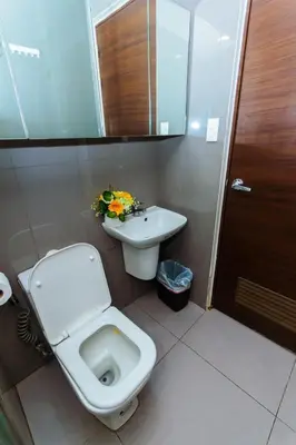 a bathroom with a toilet and a sink at 2 BR Air condo Makati Penthouse SwimGym 300Netflix 5249 in Manila