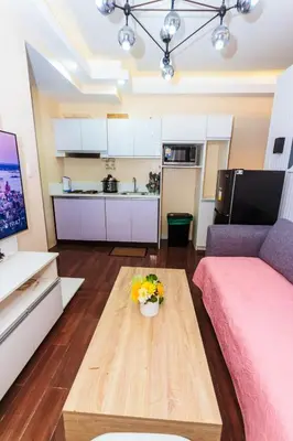 a living room with a couch and a table at 2 BR Air condo Makati Penthouse SwimGym 300Netflix 5249 in Manila