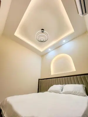 a bedroom with a white bed with a ceiling at Cozy Private Resort with Pool, Hijas Villa Binangonan in Binangonan