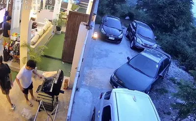 a man standing next to two cars parked in a driveway at Cozy Private Resort with Pool, Hijas Villa Binangonan in Binangonan