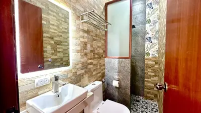 a bathroom with a sink and a toilet and a mirror at Cozy Private Resort with Pool, Hijas Villa Binangonan in Binangonan