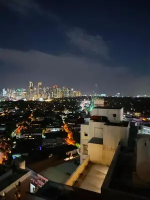 a view of a city at night at Shore Residence a31 shortwalk Mall of Asia in Manila