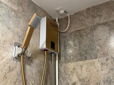 a phone on the wall of a shower in a bathroom at Shore Residence a31 shortwalk Mall of Asia in Manila