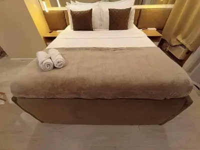a bedroom with a large bed with towels on it at Shore Residence a31 shortwalk Mall of Asia in Manila