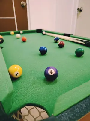 a snooker table with balls and cues on it at Aki's Place Binangonan in Binangonan