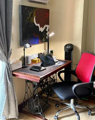 a desk with a laptop and a red chair at Mc Kinley Home Away from Home in Manila