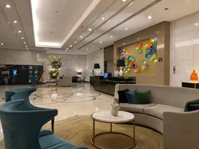 a lobby with a couch and a painting on the wall at Mc Kinley Home Away from Home in Manila