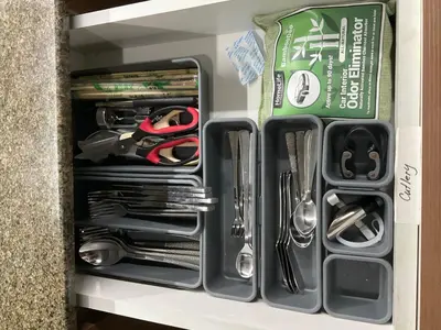 a drawer filled with utensils in a drawer at Mc Kinley Home Away from Home in Manila