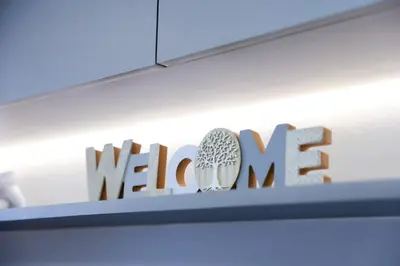 a sign on a shelf with the welcome sign at Seventh Ave in Manila