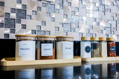 a shelf with several jars of coffee on it at Seventh Ave in Manila