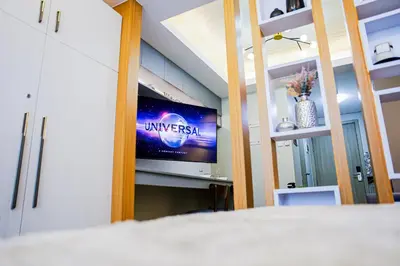 a bedroom with a tv in a room at Seventh Ave in Manila