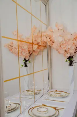 a white table with glasses and a flower arrangement at Stylish Condo at Shore 2 Residences near MOA & Airport in Manila