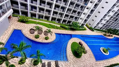an overhead view of a swimming pool in front of a building at Stylish Condo at Shore 2 Residences near MOA & Airport in Manila