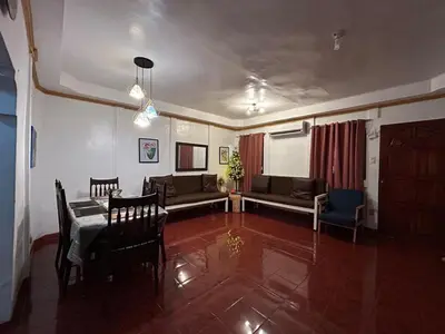 a living room with a couch and a table and chairs at Home in Imus Kawit with free mini pool in Kawit