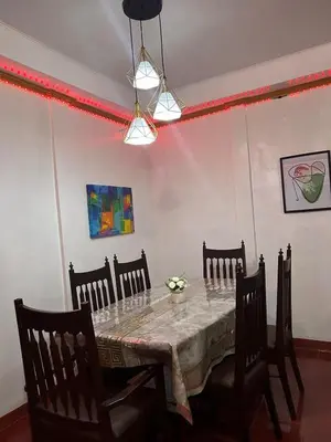 a dining room with a table and chairs at Home in Imus Kawit with free mini pool in Kawit