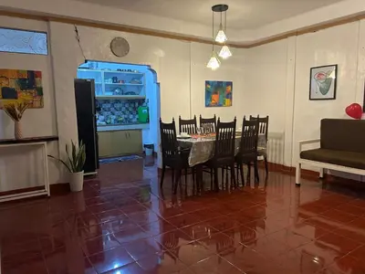a living room with a table and chairs and a refrigerator at Home in Imus Kawit with free mini pool in Kawit