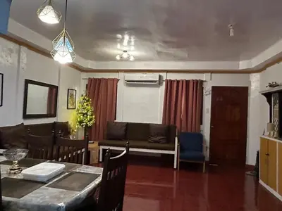 a living room with a table and a couch at Home in Imus Kawit with free mini pool in Kawit