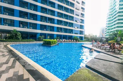 a large swimming pool in front of a building at Witty Weekend retreat Quirk Cozy in Manila