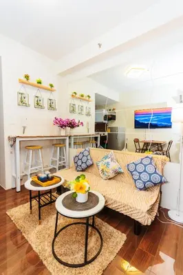a living room with a couch and a table at Witty Weekend retreat Quirk Cozy in Manila