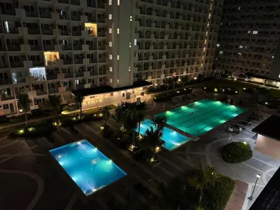an overhead view of a large building with two pools at Elite King Comfort Stay Hotel Apartment - Near Manila Airport in Manila