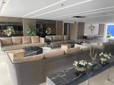 a large living room with couches and tables at Elite King Comfort Stay Hotel Apartment - Near Manila Airport in Manila
