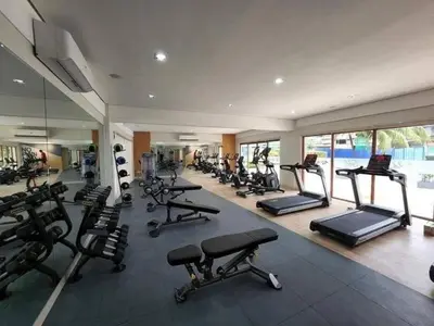 a gym with a lot of treadmills and machines at Elite King Comfort Stay Hotel Apartment - Near Manila Airport in Manila