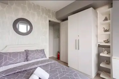 a bedroom with a purple bed and a mirror at Azure Urban Resort Residences,BORACAY tower model unit in Manila