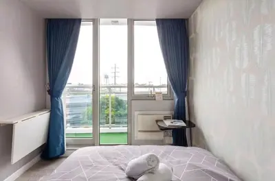 a bedroom with a bed and a large window at Azure Urban Resort Residences,BORACAY tower model unit in Manila