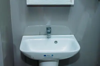 a white sink in a bathroom with a window at Urban Charm Cozy Meet 51 Air Swim Gym Park 300Mb in Manila