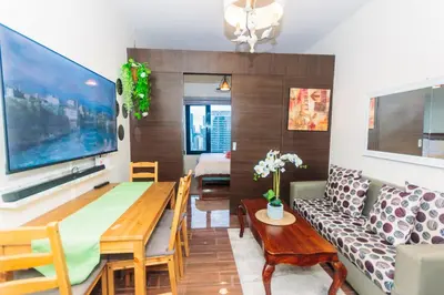 a living room with a couch and a table at Urban Charm Cozy Meet 51 Air Swim Gym Park 300Mb in Manila