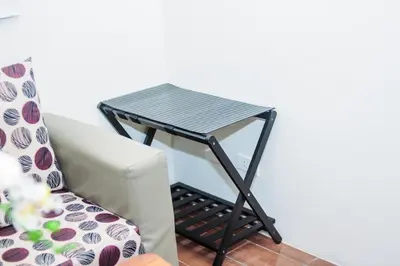 a small black table sitting next to a couch at Urban Charm Cozy Meet 51 Air Swim Gym Park 300Mb in Manila