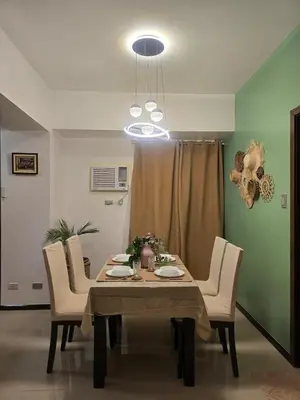 a dining room with a table and chairs at The Radiance of Manila Bay in Manila