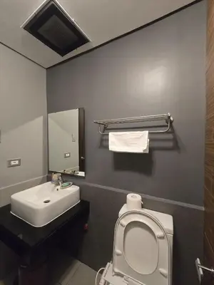 a bathroom with a white toilet and a sink at The Radiance of Manila Bay in Manila