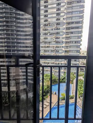 a view from the balcony of a building with a pool at Charming Comfort 1BR at Air Residences Makati with wifi & netflix in Manila