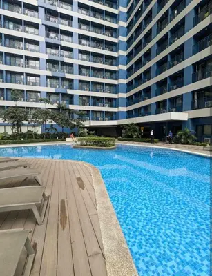 a large apartment building with a large swimming pool at Charming Comfort 1BR at Air Residences Makati with wifi & netflix in Manila
