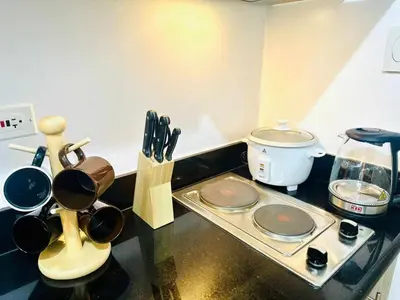 a kitchen counter with pots and pans on a stove at Cozy Retreat at Shore2 Residences in Manila