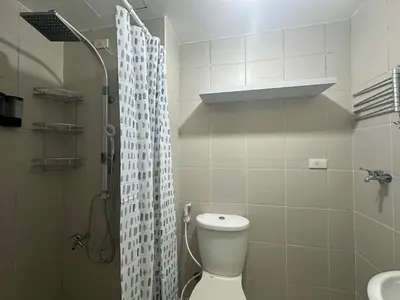 a bathroom with a toilet and a shower and a sink at Modern & Cozy Two BR in Jazz Residences Makati City in Manila