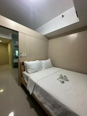 a bedroom with a bed with two cups on it at Modern & Cozy Two BR in Jazz Residences Makati City in Manila