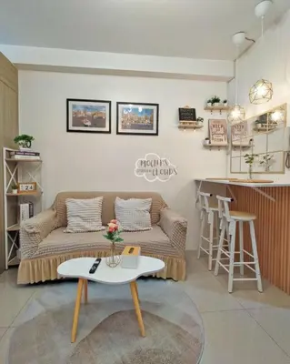 a living room with a couch and a table at Condotel with Balcony Near Airport and MOA with Games & Karaoke in Manila