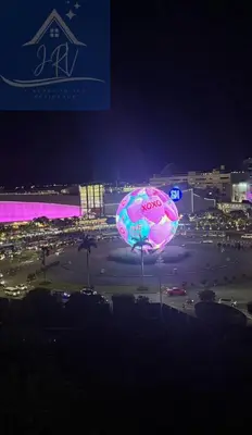 a large pink and blue balloon in a parking lot at night at 1bedroom with balcony at Sea Residences near MOA and SMX in Manila