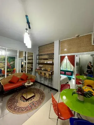 a living room with a couch and a table at Tropical unit in Manila